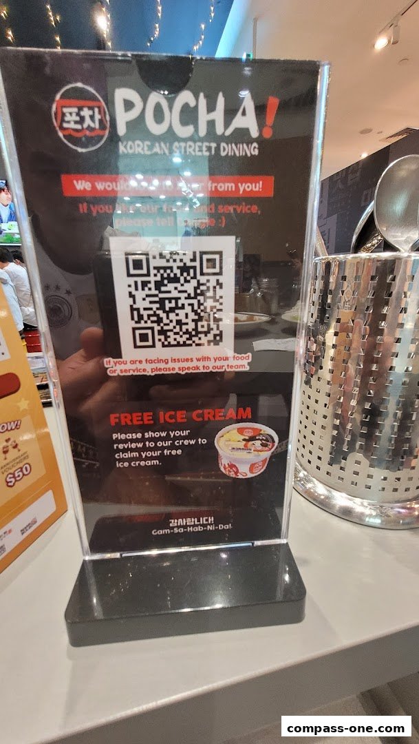 A sign offering free ice cream for reviews at POCHA! Korean Street Dining.