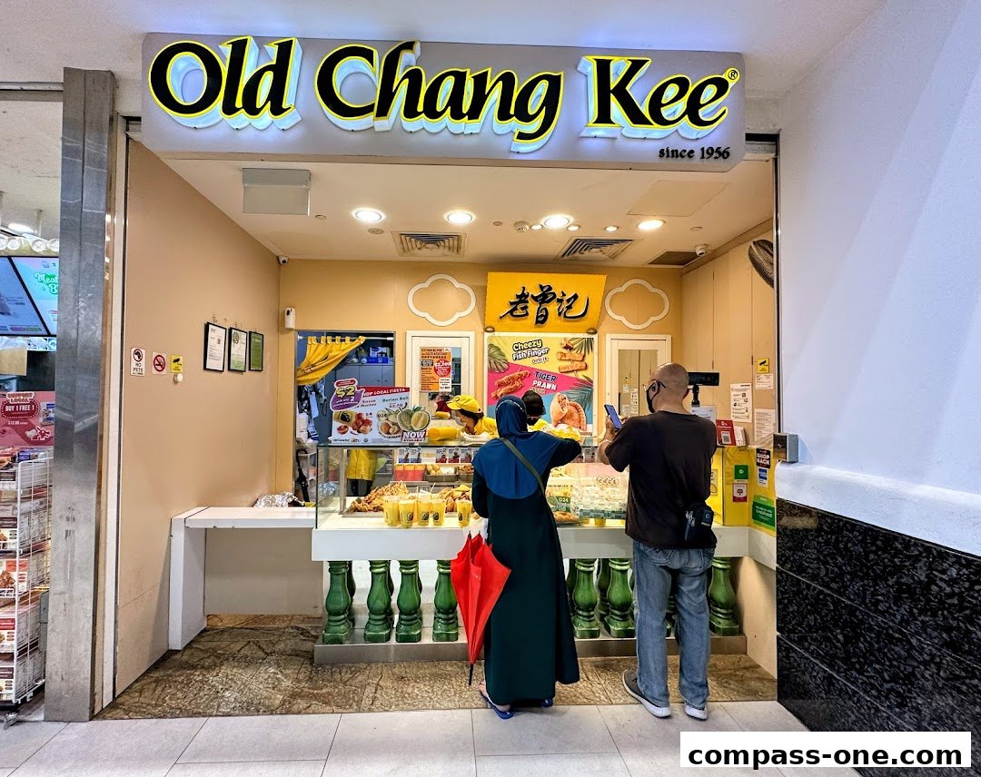 Old Chang Kee shop front with customers ordering food.