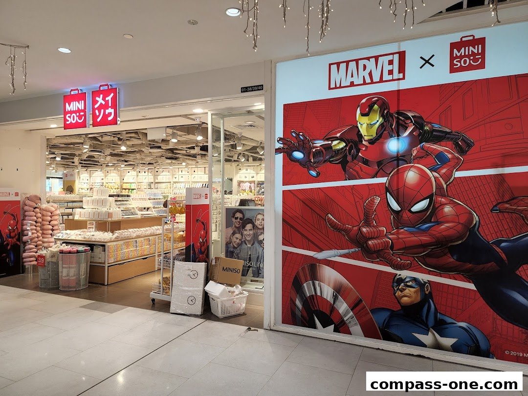 The entrance of a MINISO store featuring a large Marvel collaboration display with Iron Man, Spider-Man, and Captain America.
