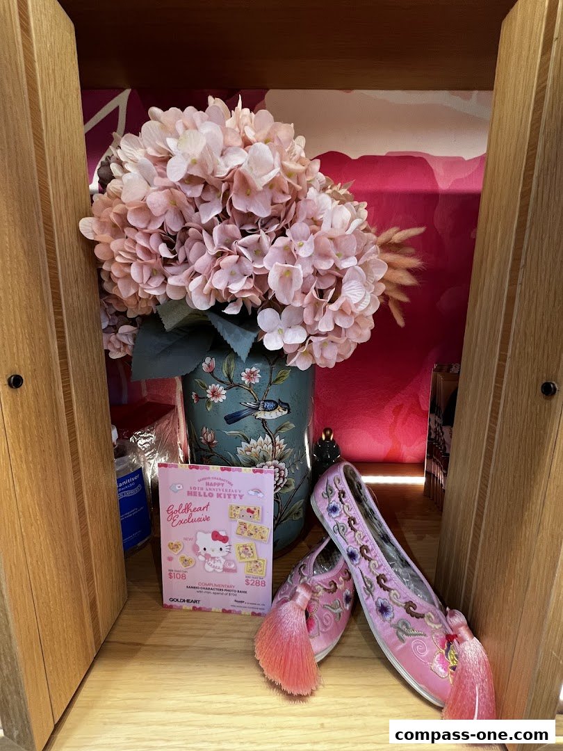 A display featuring pink Hello Kitty themed items, including shoes and promotional material.