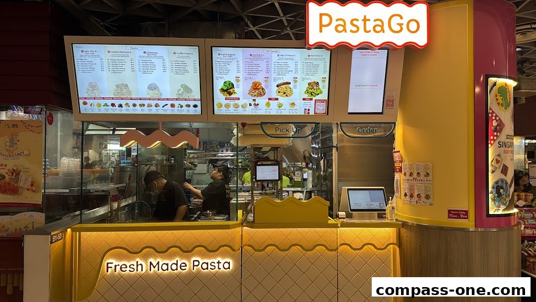 A brightly lit PastaGo shop with digital menus displaying pasta options and staff preparing food.
