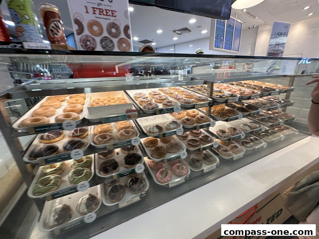 A display case filled with a variety of freshly made donuts at Krispy Kreme.