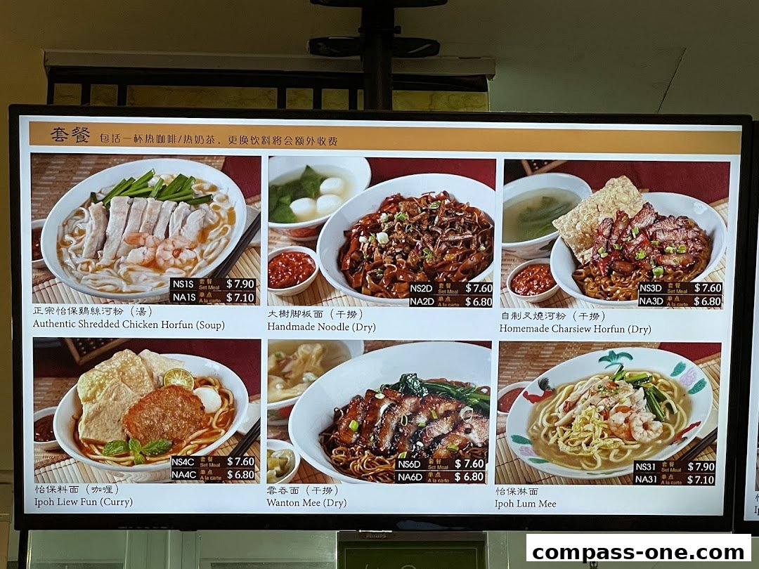 A digital menu board displaying various Ipoh delicacies with images and prices.