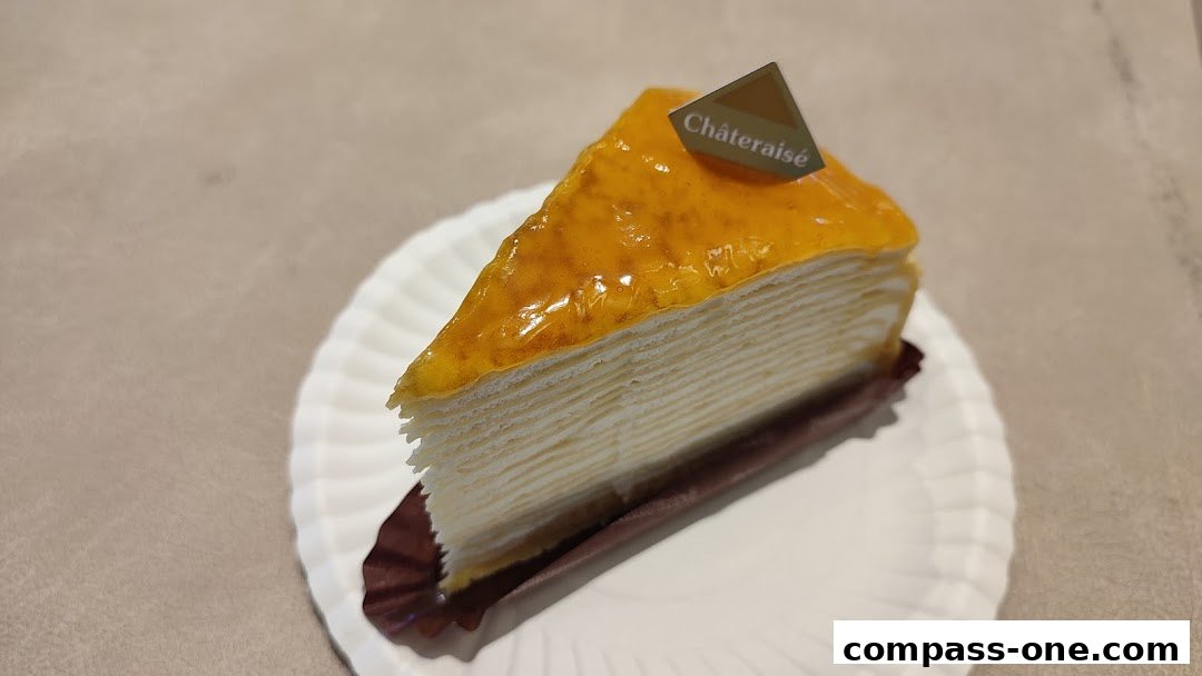 A slice of layered cake with orange glaze and a Châteraisé branded flag.