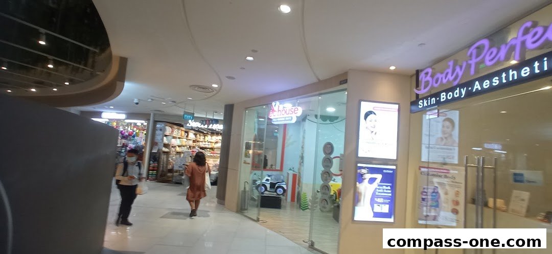 The exterior of EC House All Range Cuts and Body Perfect aesthetic clinics in a mall.