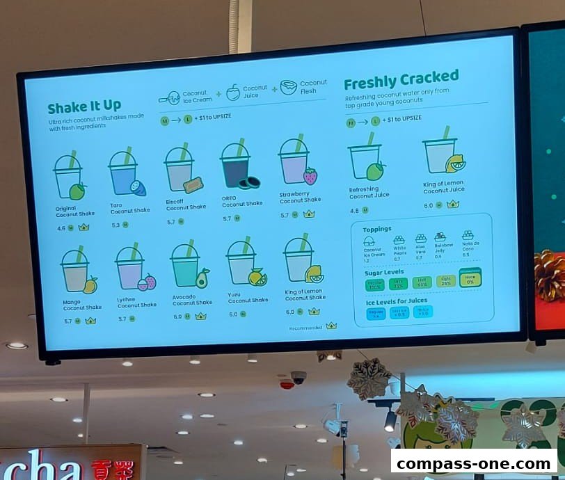 A digital menu board displaying various coconut shakes and juices with prices.