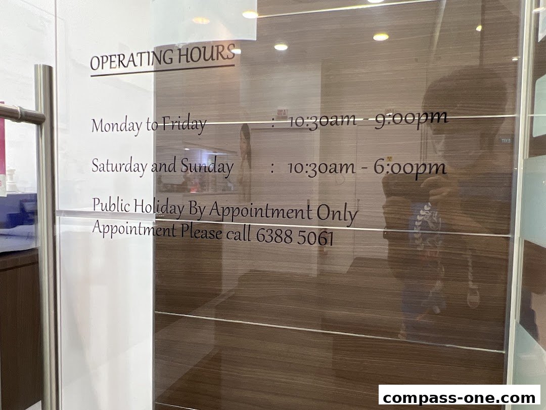 Operating hours and contact information for iSmile Dental Surgery displayed on glass.