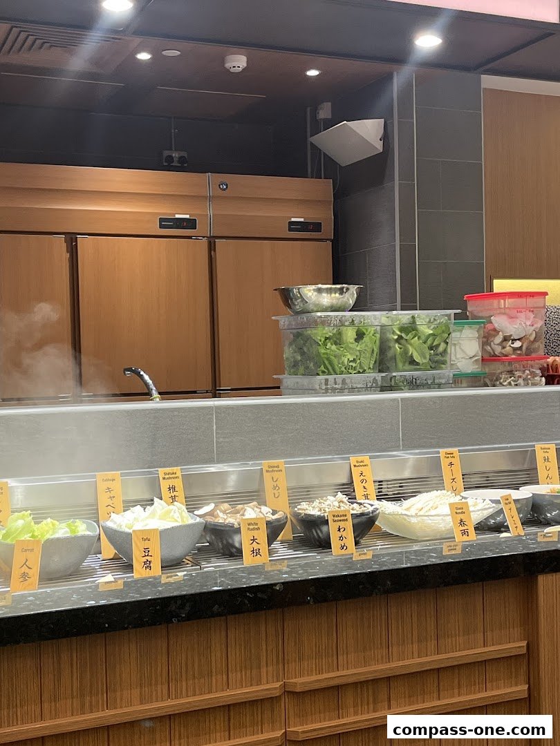 A display of fresh ingredients for hot pot, including vegetables, tofu, and mushrooms.
