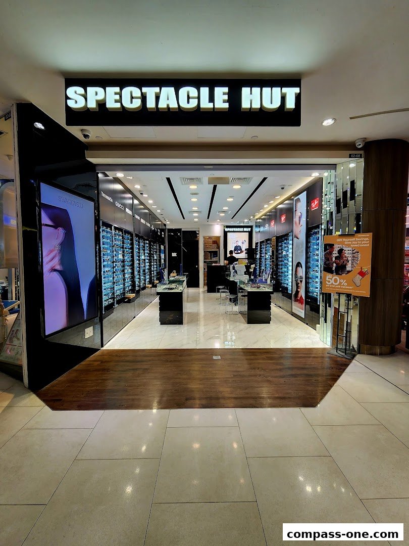 The entrance of Spectacle Hut, an optical shop, displaying various eyewear and promotions.