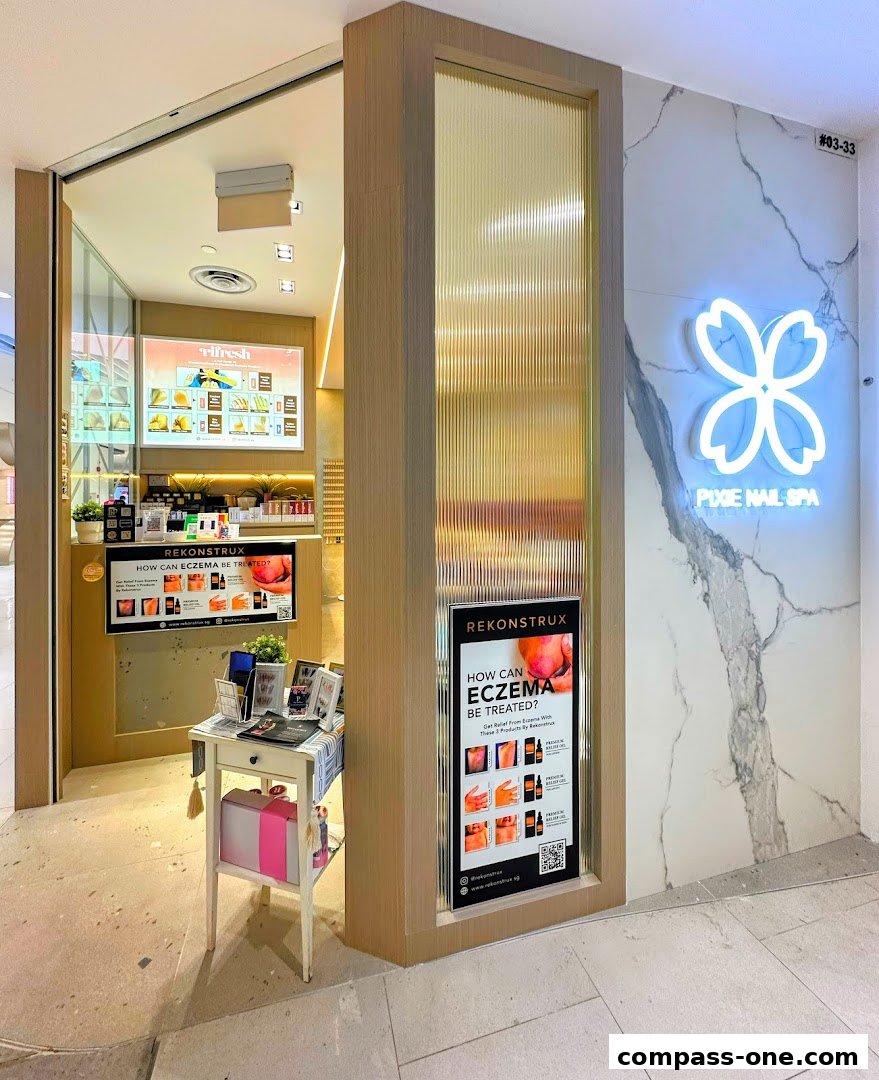 The exterior of Pixie Nail Spa, featuring a neon sign and promotional displays.