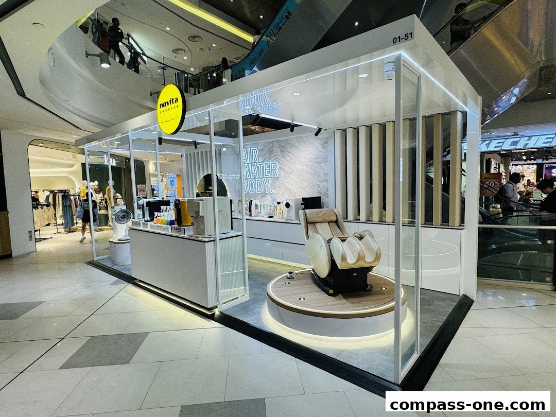 A Novita shop display featuring a massage chair and water purifier in a mall.