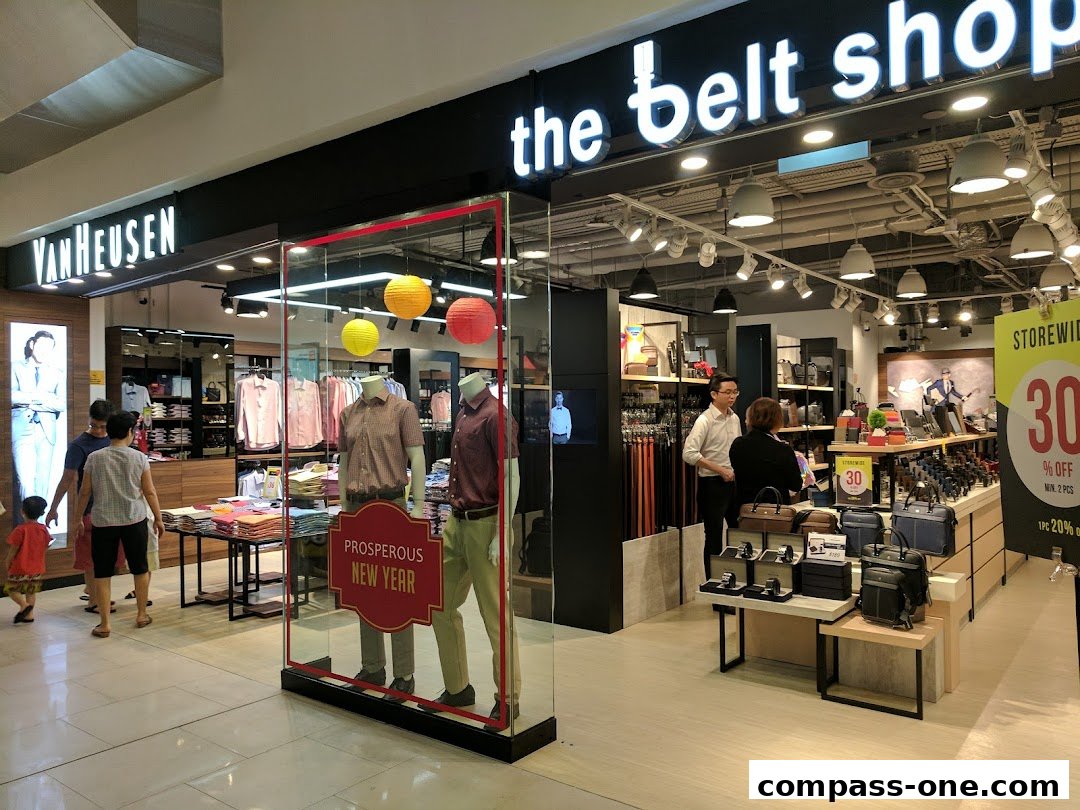 The Van Heusen and The Belt Shop storefronts display clothing and accessories with a New Year promotion.