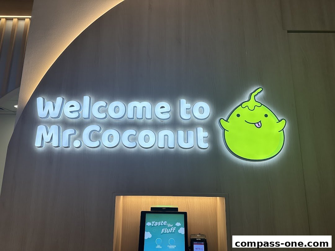 Welcome sign for Mr. Coconut with a cute coconut character and a digital ordering kiosk.
