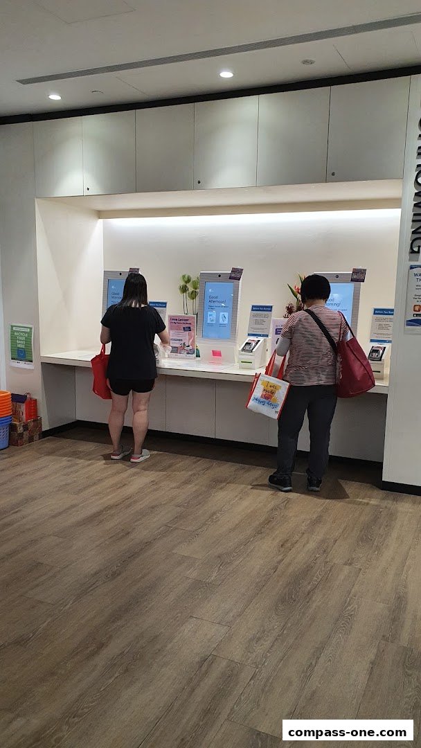 People using self-service kiosks at Sengkang Public Library.