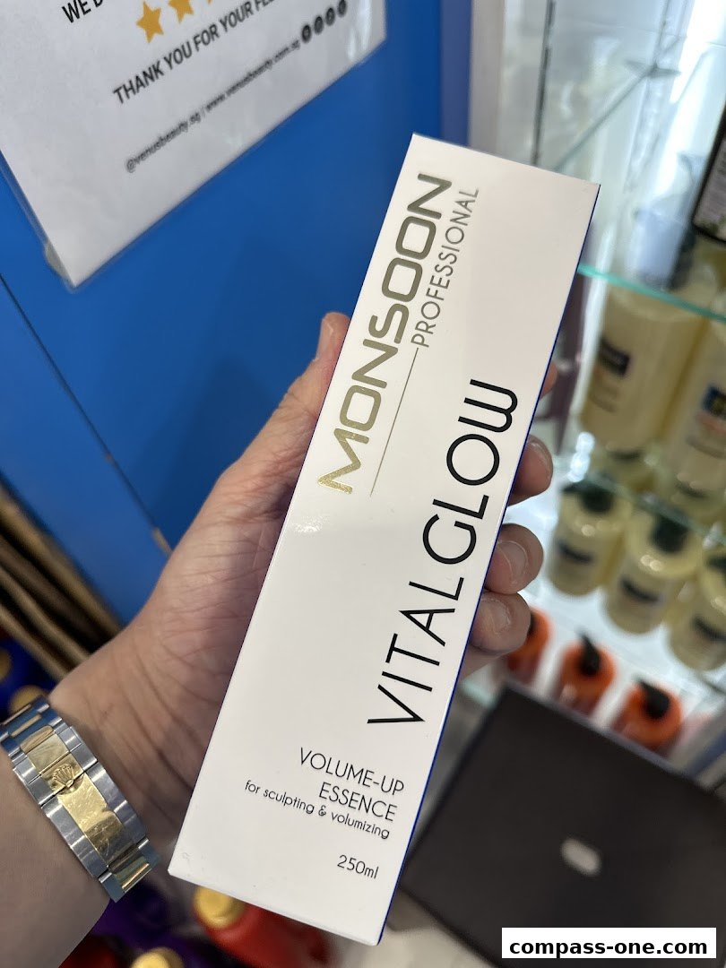 A hand holds a box of Monsoon Professional Vital Glow Volume-Up Essence.