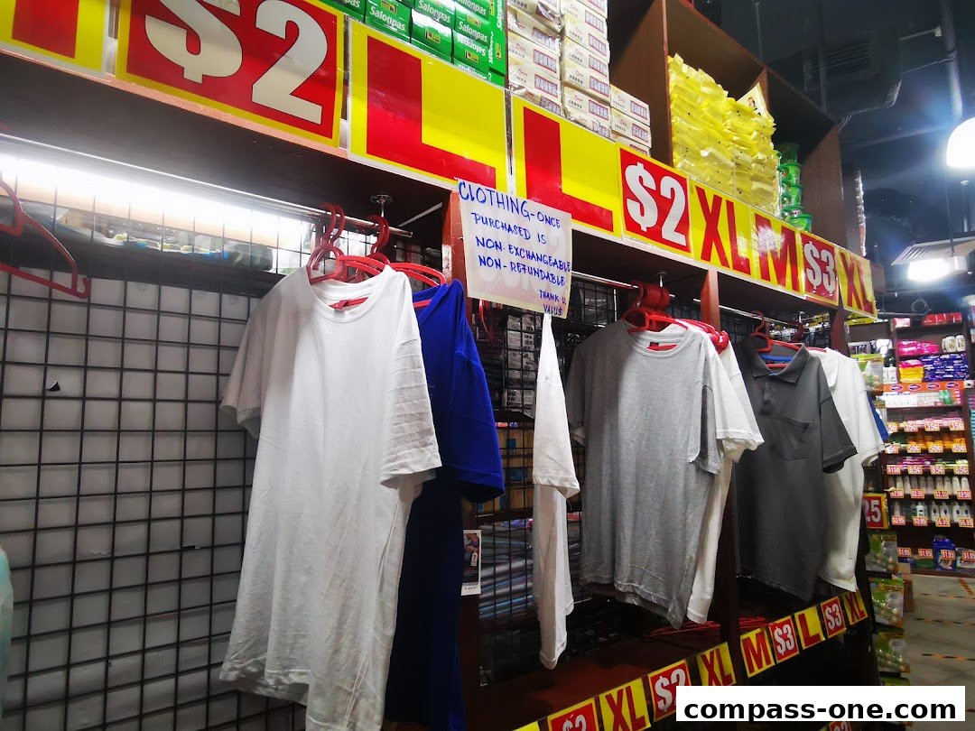 T-shirts displayed on racks with price tags and store signage.