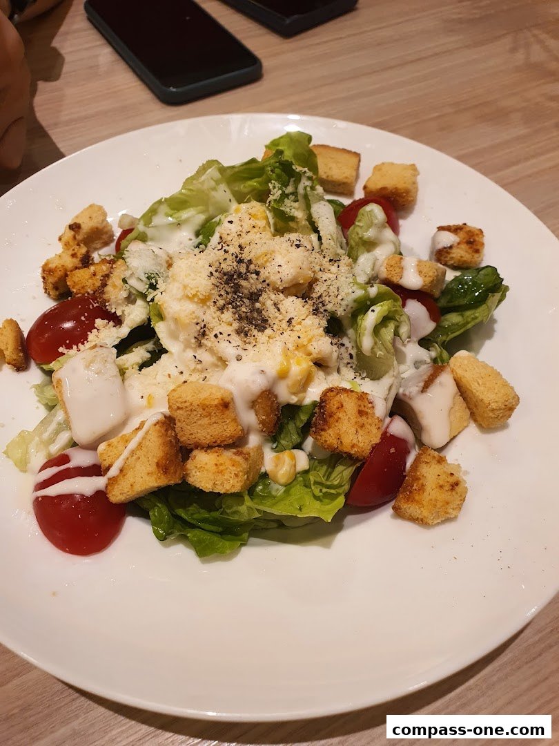 A close-up shot of a delicious Caesar salad with croutons, cherry tomatoes, and dressing.