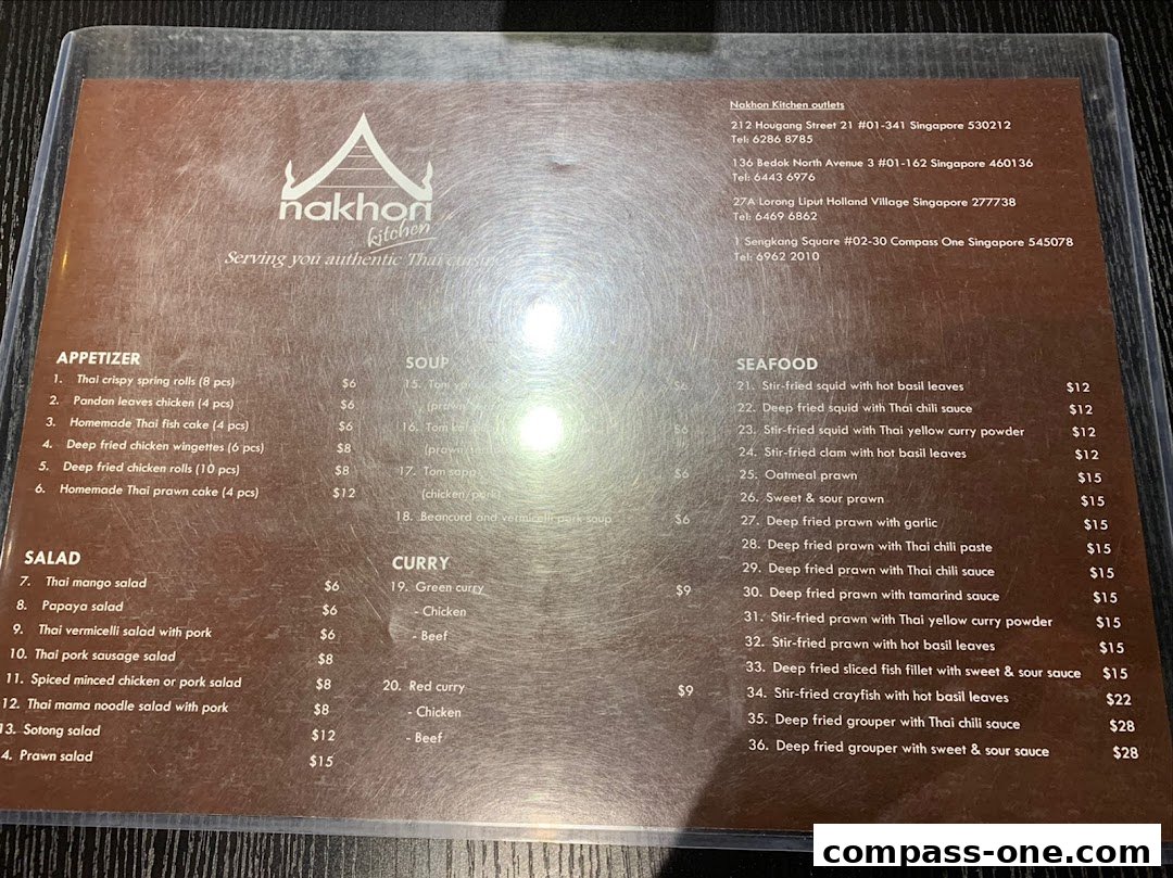 A menu from Nakhon Kitchen, featuring Thai appetizers, salads, soups, curries, and seafood dishes.