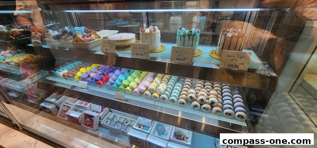 A display case filled with colorful macarons, cakes, and other pastries at Annabella Patisserie.