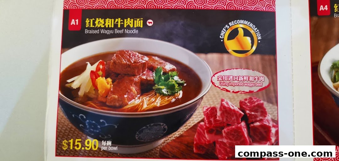 A close-up of a bowl of Braised Wagyu Beef Noodles with a side of raw wagyu beef.
