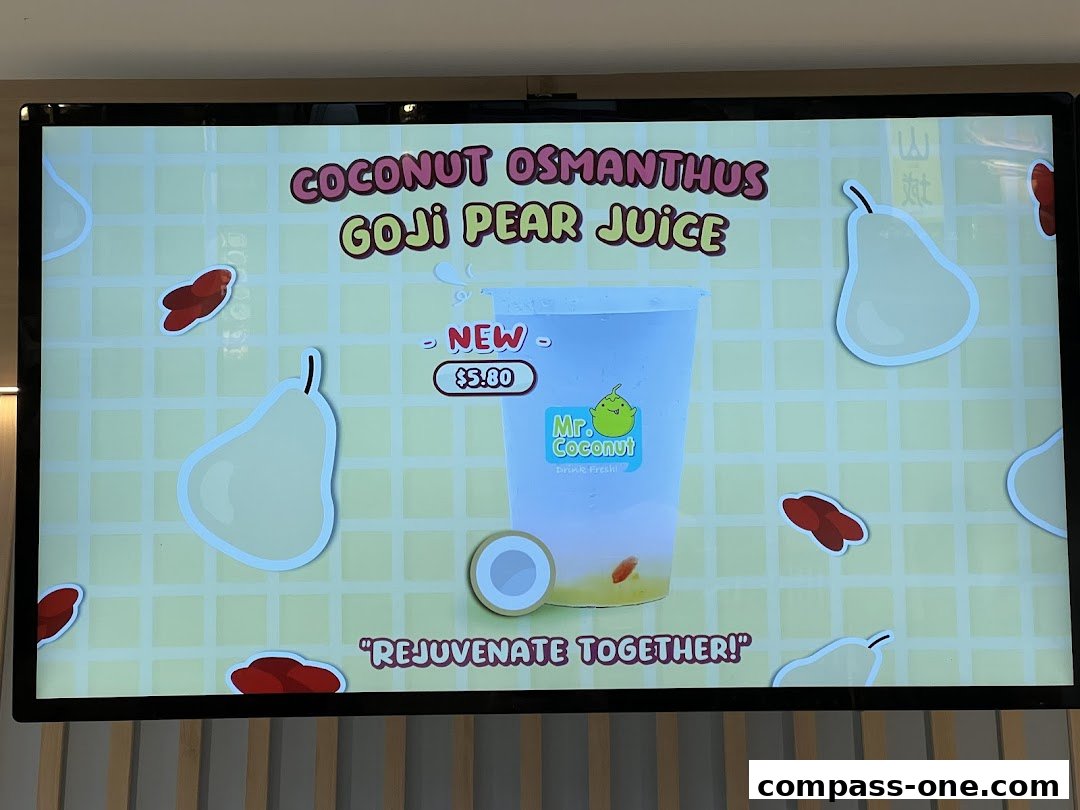 A digital menu board displaying a new Coconut Osmanthus Goji Pear Juice from Mr. Coconut.