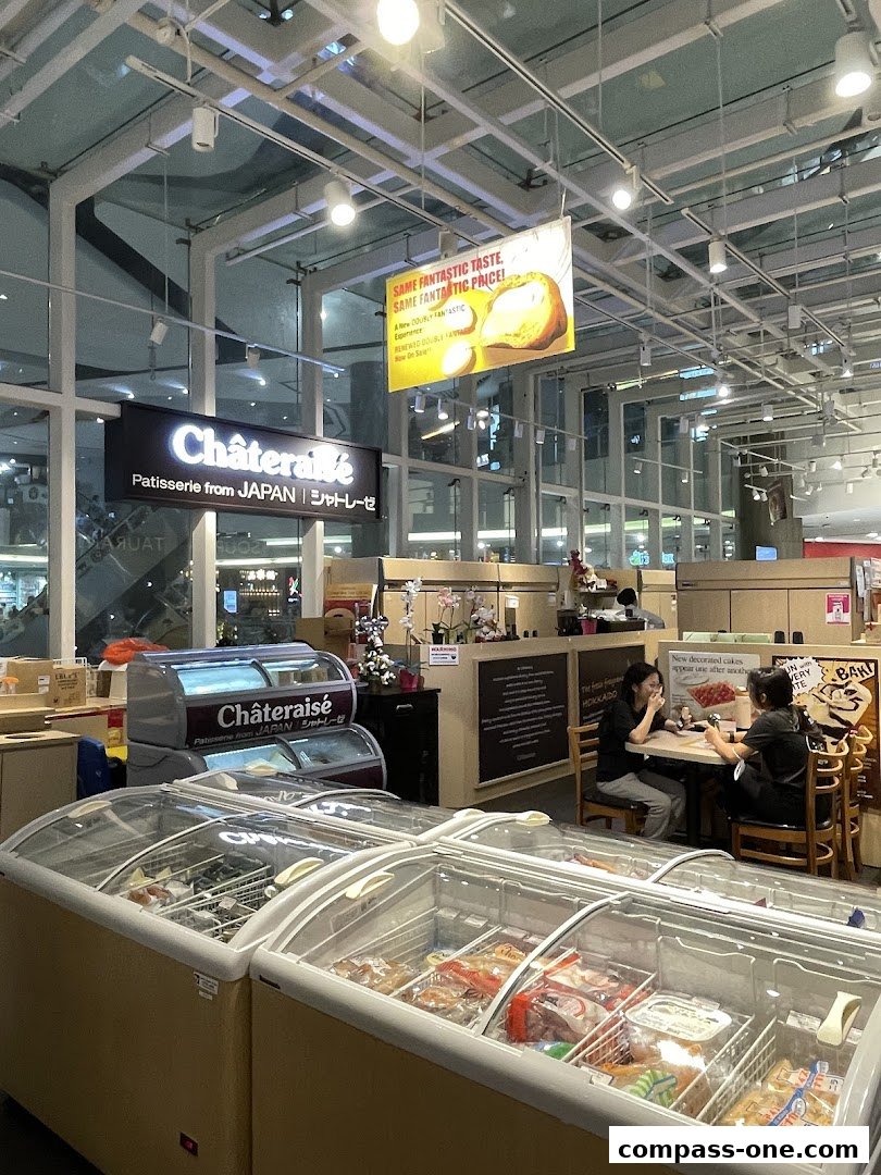 Interior of a Châteraisé patisserie with display freezers and seating area.