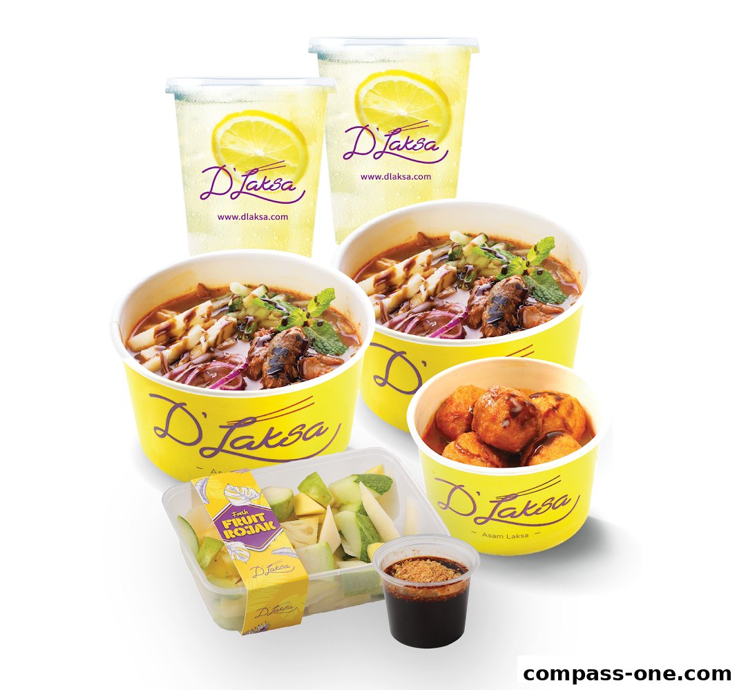 A spread of D Laksa meals including laksa, drinks, fruit rojak, and fried snacks.