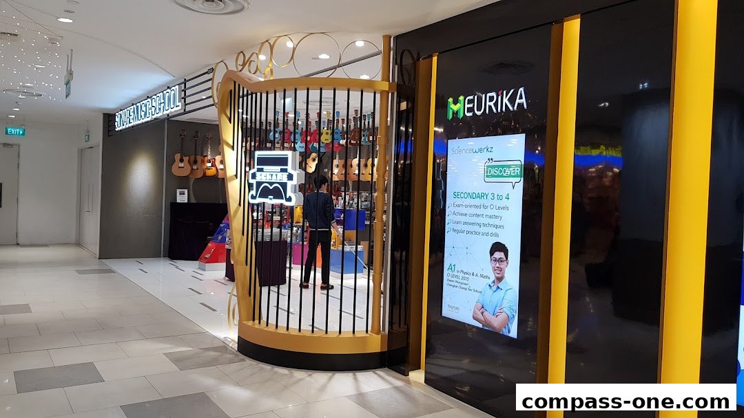 The entrance to Stalford Learning Centre Sengkang, Compass One, showcasing guitars and an advertisement for Sciencewerkz.