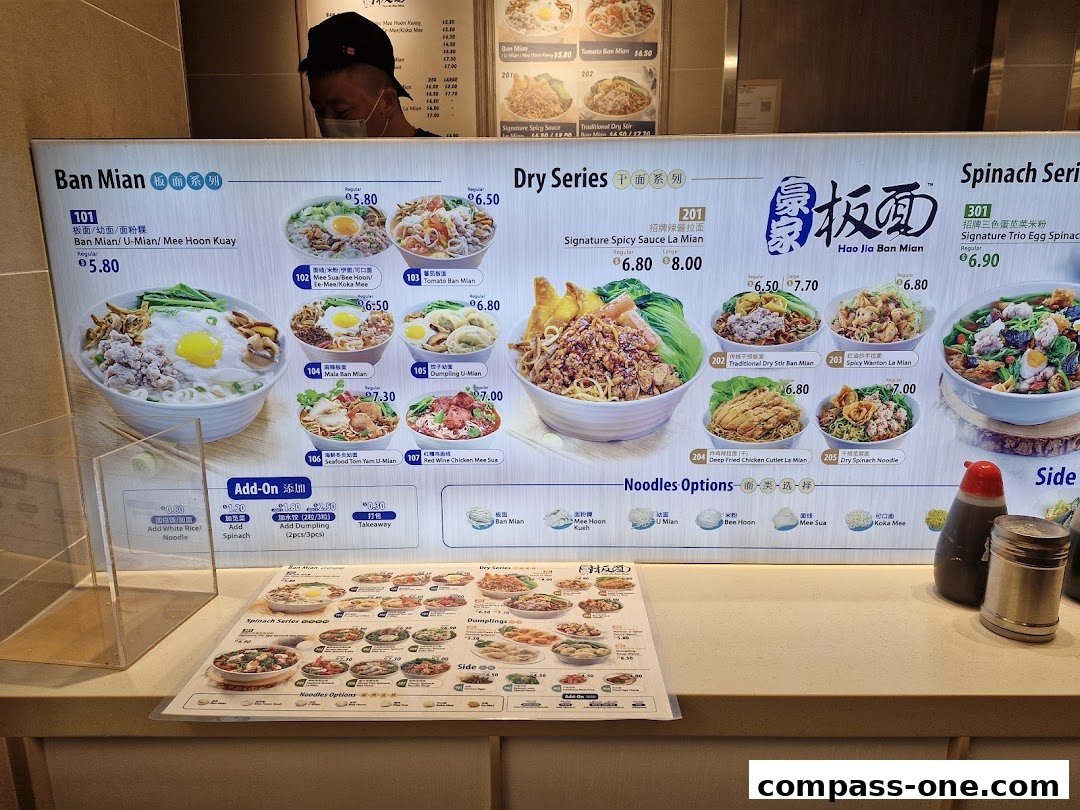 A menu board displaying various noodle dishes with appetizing images and prices.