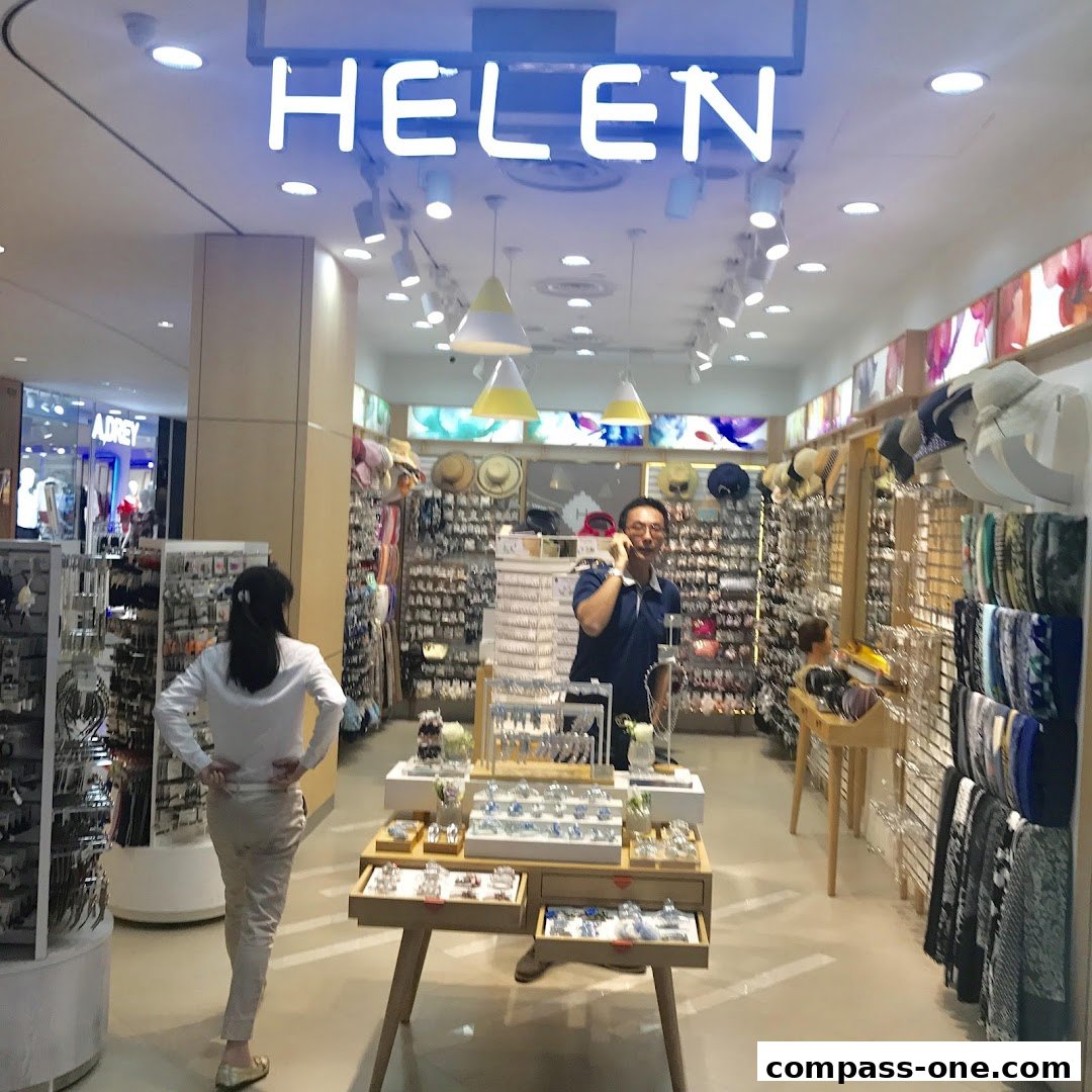 A well-lit jewelry and accessories store with a wide selection of items and a staff member assisting a customer.