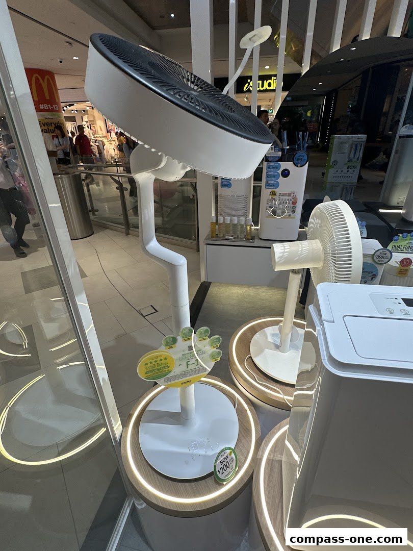 A display of modern fans and air purifiers in a retail store.