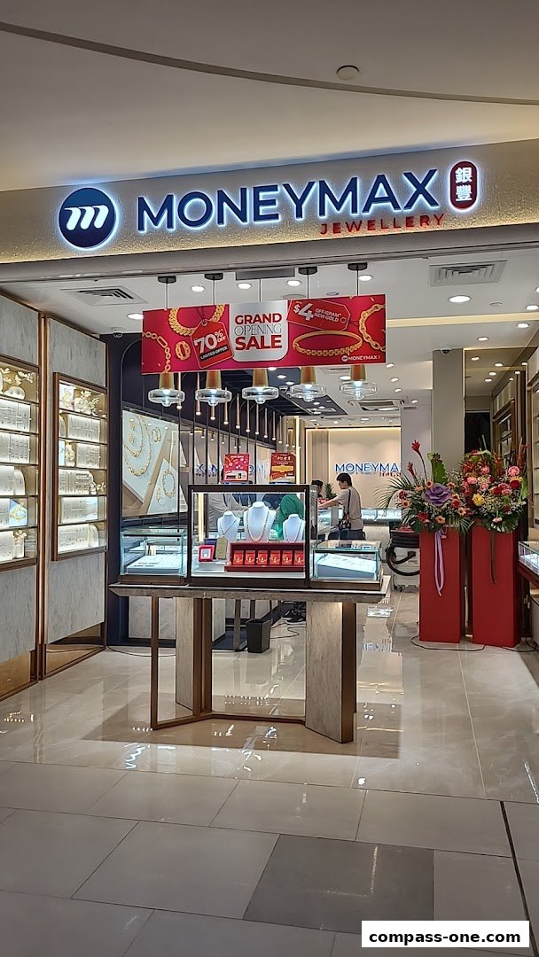 The entrance of MoneyMax Jewellery shop with displays of necklaces and promotional banners.