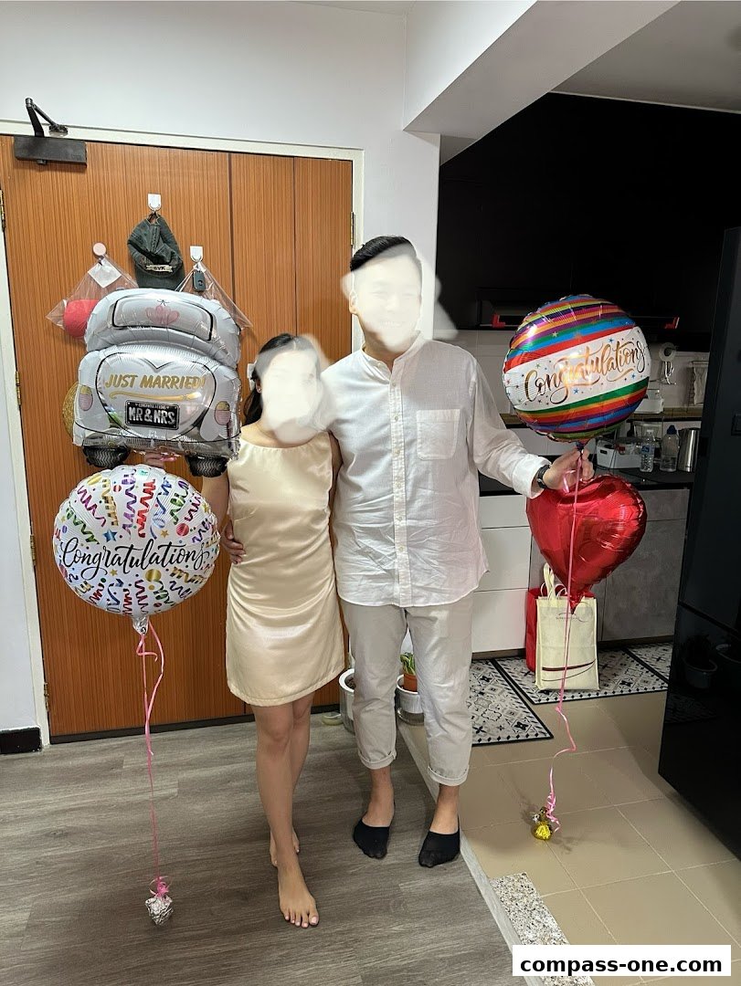 A couple poses with balloons, including a 'Just Married' car and 'Congratulations' balloons.