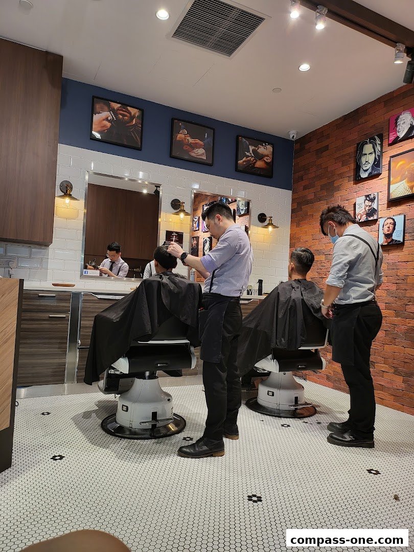 Barbers are cutting hair for customers in a stylish barbershop with artwork on the walls.