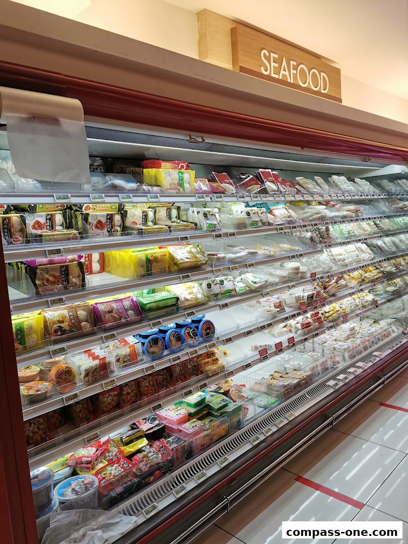 A refrigerated display case filled with various packaged food items, including seafood.