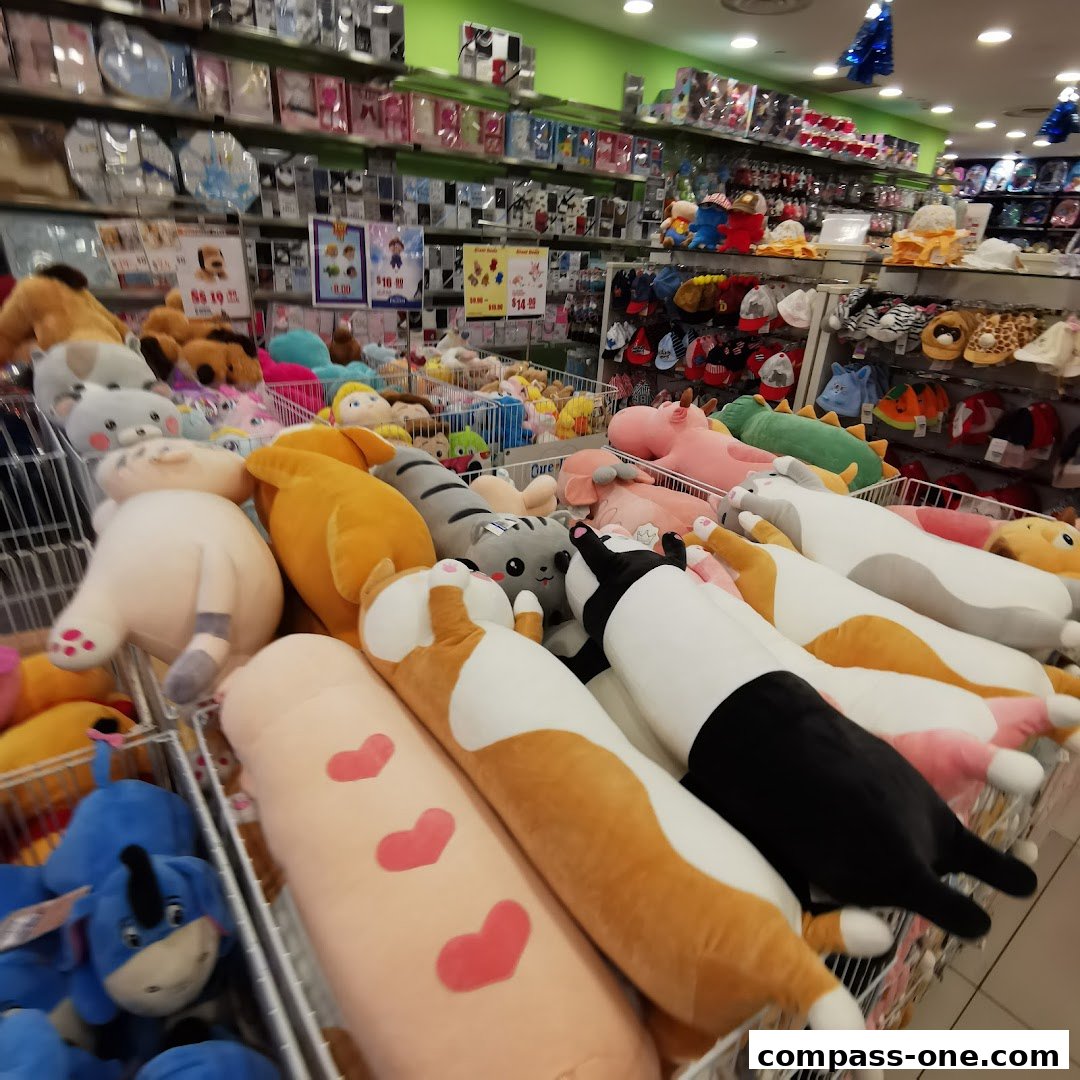 A wide variety of plush toys, including long cat-shaped pillows and stuffed animals, are displayed in baskets.