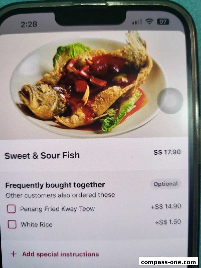 A phone screen displaying a Sweet & Sour Fish dish with accompanying items.
