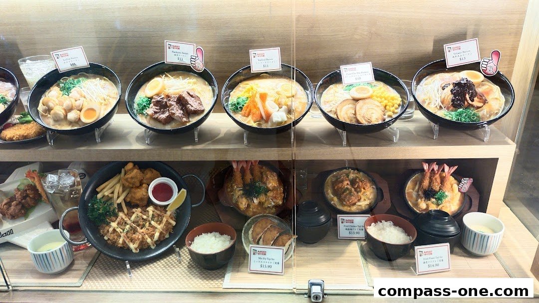A display of realistic ramen and Japanese food models in a shop window.