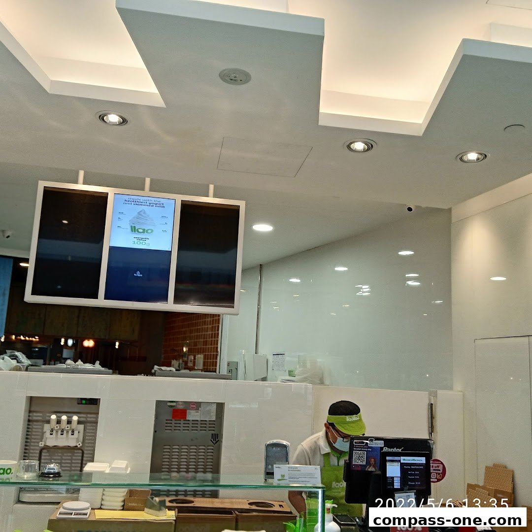 A cashier at the llaollao frozen yogurt shop serves a customer.