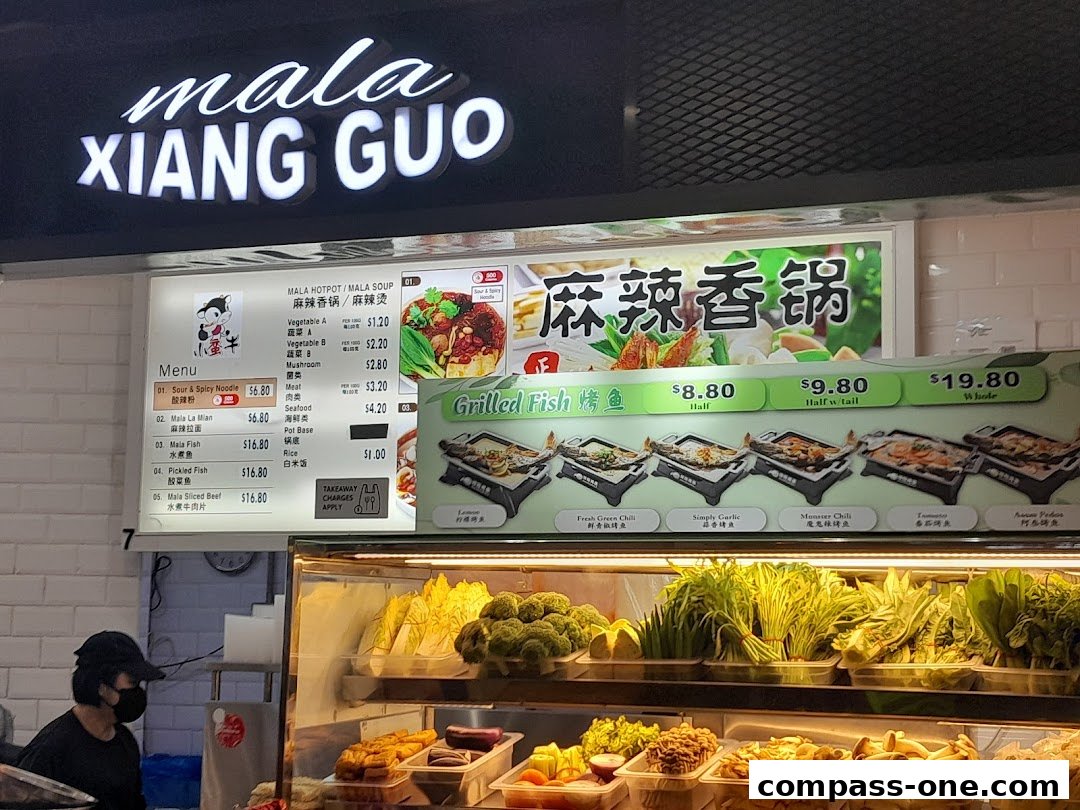 A menu board for Mala Xiang Guo featuring various dishes and ingredients, with a selection of grilled fish options.