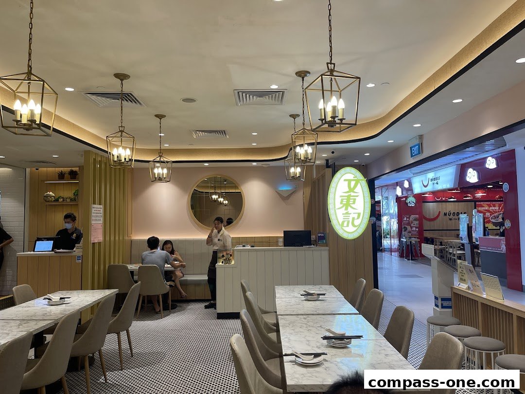 Interior of Boon Tong Kee restaurant with dining tables, chairs, and staff serving customers.