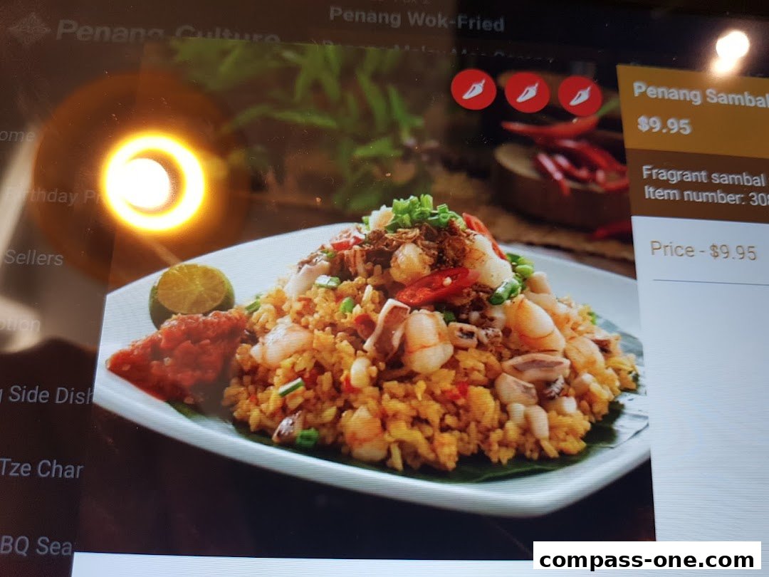 A digital menu displays a plate of Penang Sambal fried rice with seafood and chili icons.