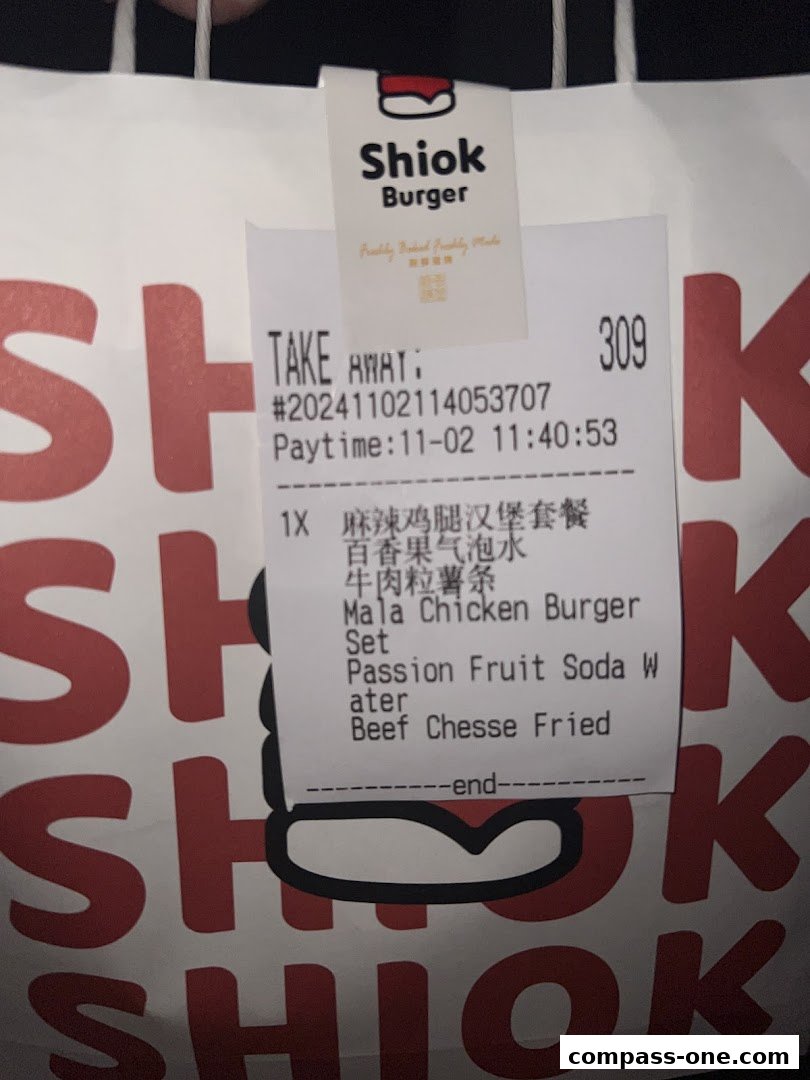 A receipt from Shiok Burger showing a Mala Chicken Burger set with sides and a drink.