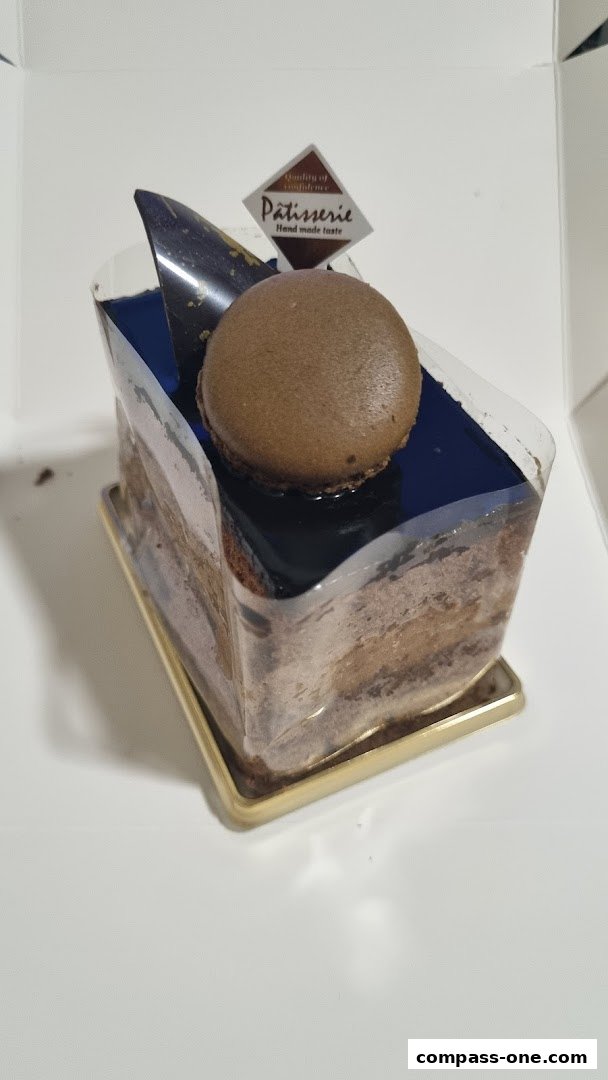 A slice of chocolate cake with a macaron and chocolate decoration from Four Leaves.