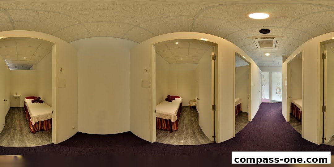 Interior view of a spa with multiple treatment rooms, each featuring a massage bed.