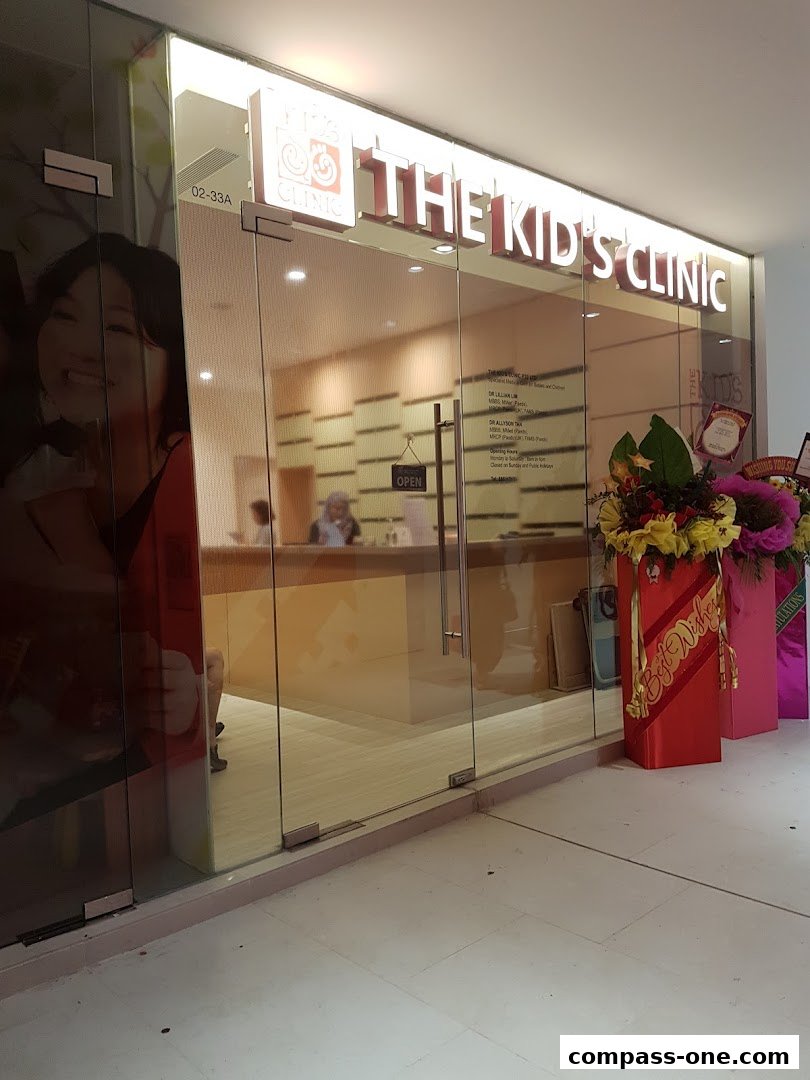 The entrance to 'The Kid's Clinic' with a bright sign and glass doors.