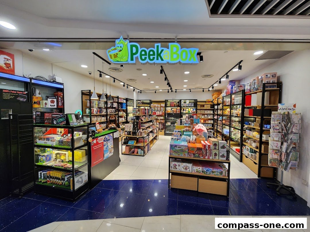 The interior of a brightly lit retail store named Peek A Box, filled with various toys and gifts.