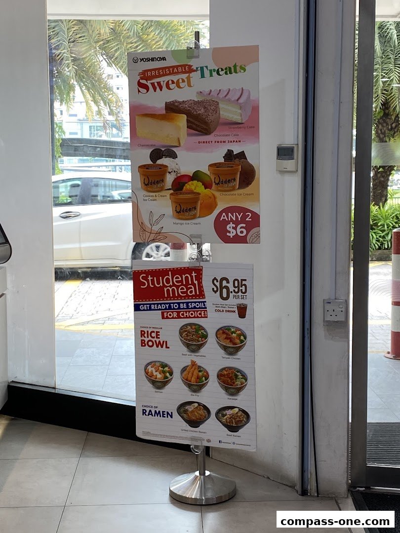 A promotional sign for Yoshinoya featuring sweet treats and a student meal deal.
