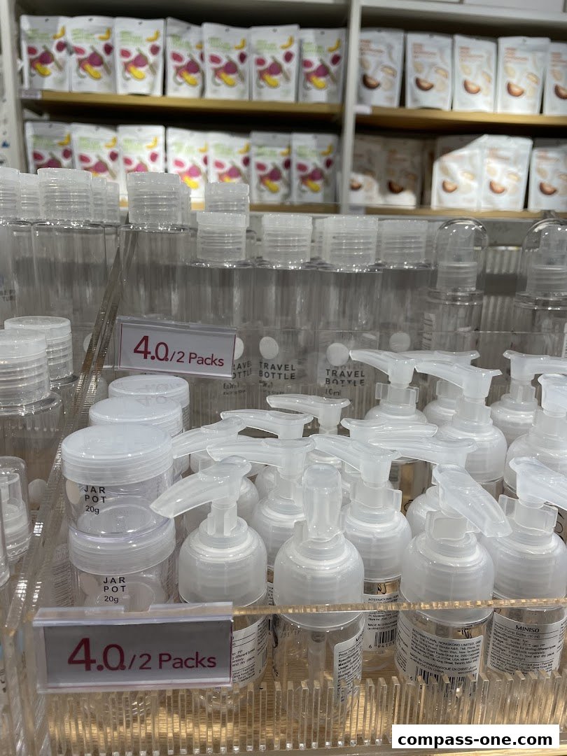A display of travel-sized bottles and jars at MINISO Compass One.