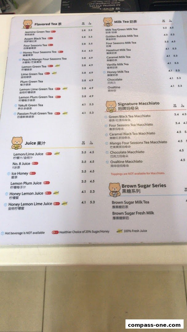 A menu from KOI Thé showing various flavored teas, juices, milk teas, and signature macchiatos.